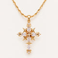 Gold Celestial Gothic Cross Necklace with Clear Zirconia Accents on an Ivory Background