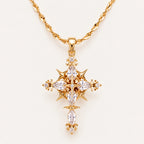 Gold Celestial Gothic Cross Necklace with Clear Zirconia Accents on an Ivory Background