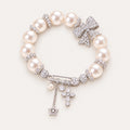 French-Inspired Pearl Bow Charm Bracelet – Crystal Cross & Star Statement Jewelry
